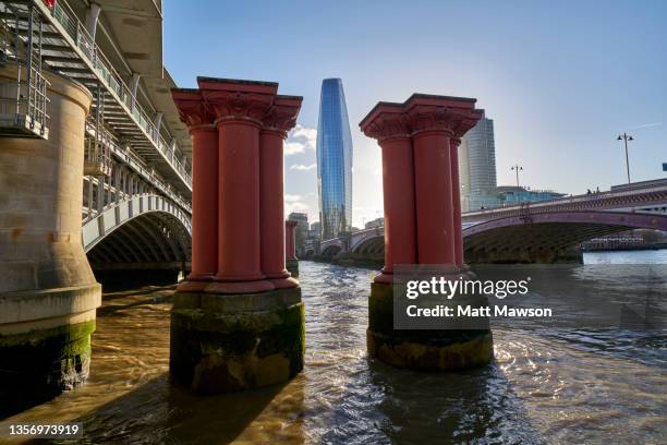 one blackfriars building, blackfriars bridge and blackfriars railway bridge over the thames river. london england uk. - blackfriars bridge stock pictures, royalty-free photos & images