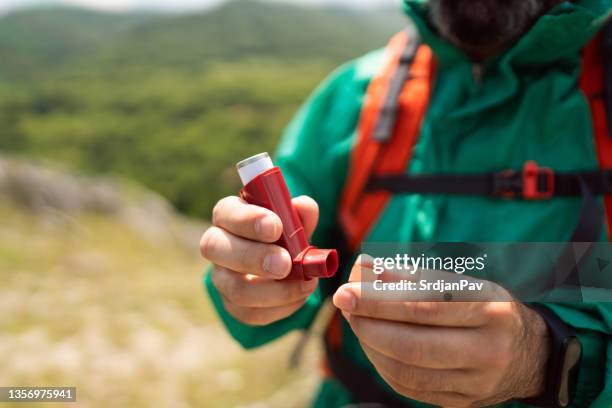 unrecognizable active man, opening his asthma inhaler - open rucksack stock pictures, royalty-free photos & images