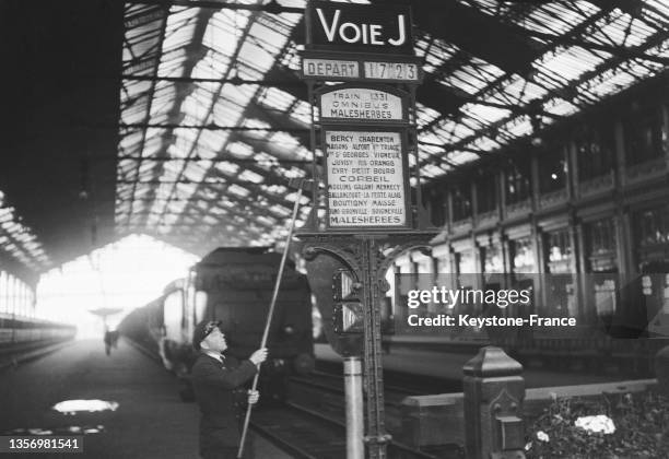 Panneau d'affichage sur un quai Gare de Lyon à Paris, en juillet 1937.