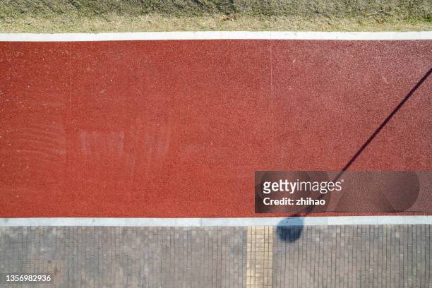 a bird's eye view of the shadows of the street lights on the pavement - traffic light empty road stock pictures, royalty-free photos & images
