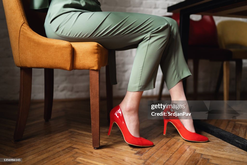 Unrecognizable woman in red high heels