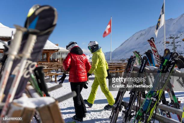 Skiers are seen in front of a restaurant in Samnaun on the Swiss side of the Ischgl ski resort during the fourth wave of the coronavirus pandemic on...