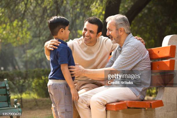 three generation spending leisure time at park - garden bench stock pictures, royalty-free photos & images