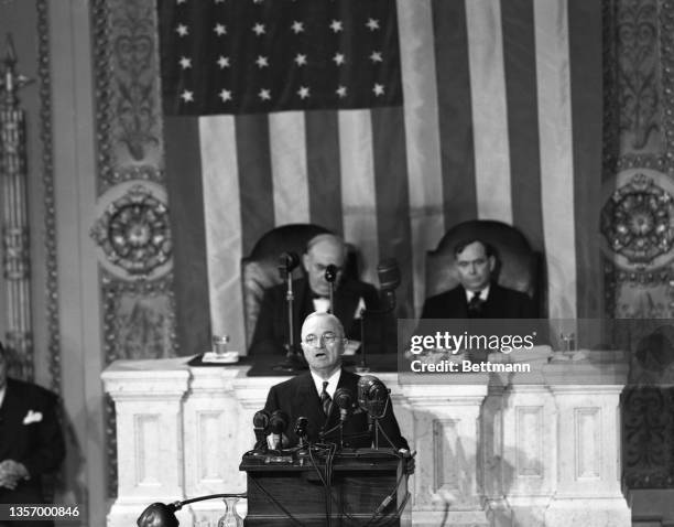 President Truman delivers his annual State of the Union message to a joint session of Congress. On the rostrum behind the President are Senator...