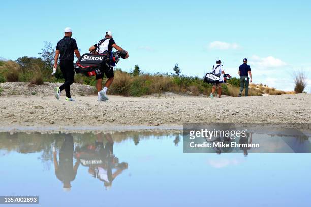 Brooks Koepka of the United States and Justin Thomas of the United States walk up the third hole during the second round of the Hero World Challenge...