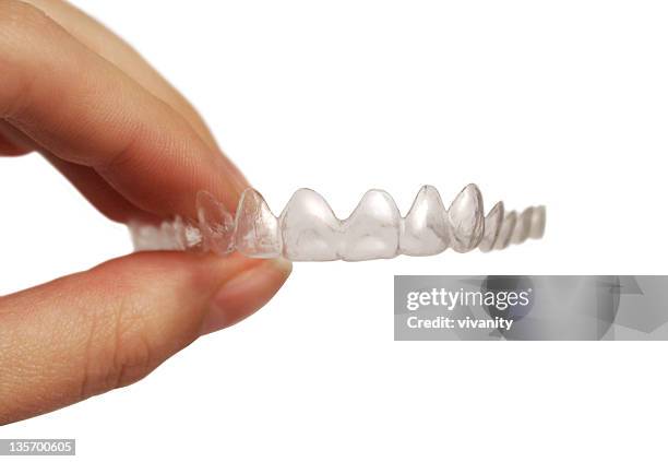 hand holding invisible retainer - invisalign stockfoto's en -beelden