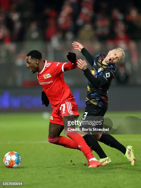 Sheraldo Becker of 1.FC Union Berlin pushes off a tackle by Angelino of RB Leipzig during the Bundesliga match between 1. FC Union Berlin and RB...