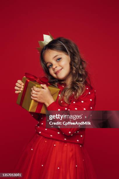 cute blue-eyed girl holding a gift box - girls dress stock pictures, royalty-free photos & images