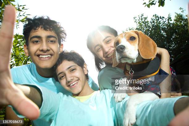 teenagers with pet dog talking selfie - player portraits stock pictures, royalty-free photos & images