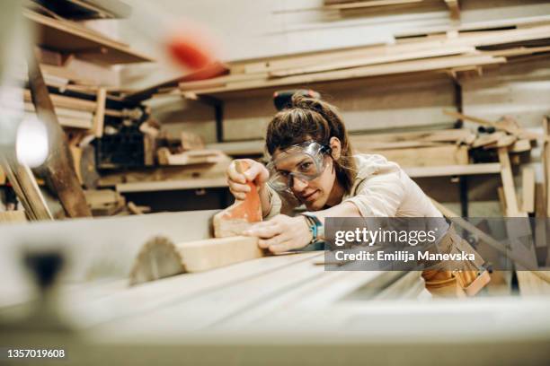 young woman working in industry. - carpentry tools stock-fotos und bilder