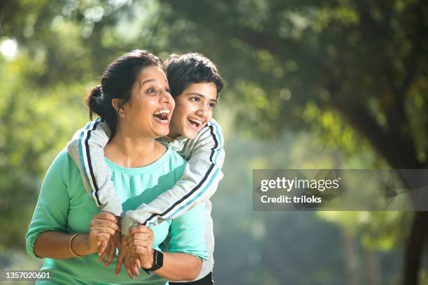 mother and daughter having fun at the park - indian mother and child stock pictures, royalty-free photos & images