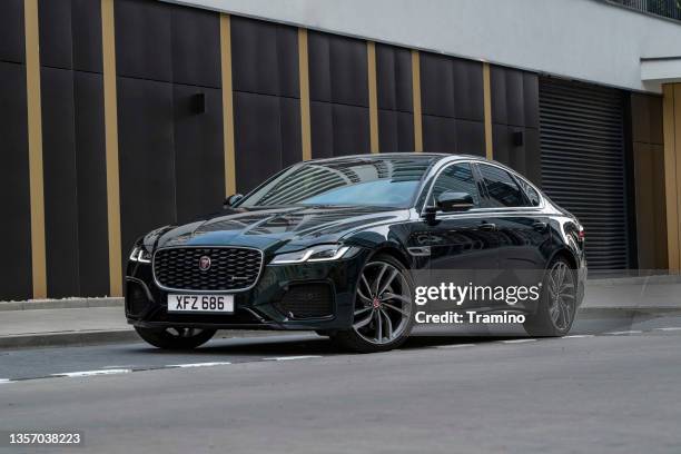 premium limousine jaguar xf on a street - saloon car stock pictures, royalty-free photos & images