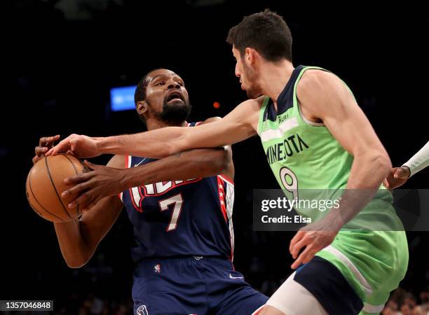 Kevin Durant of the Brooklyn Nets heads to the net as Leandro Bolmaro of the Minnesota Timberwolves is called for a foul on this play in the second...