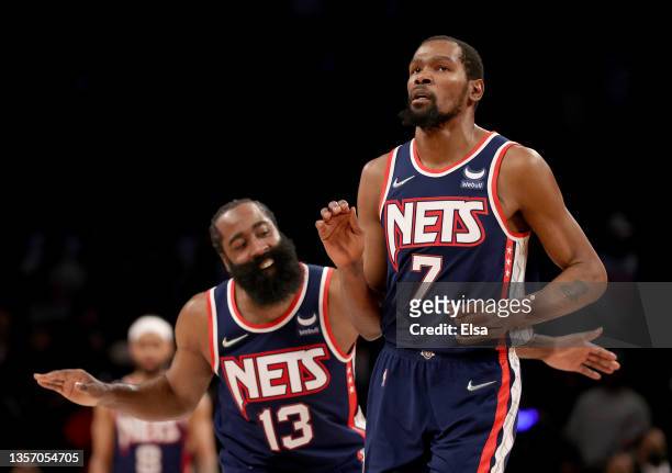 James Harden of the Brooklyn Nets congratulates teammate Kevin Durant after Durant hit a shot to secure the lead in the final minute of the game...