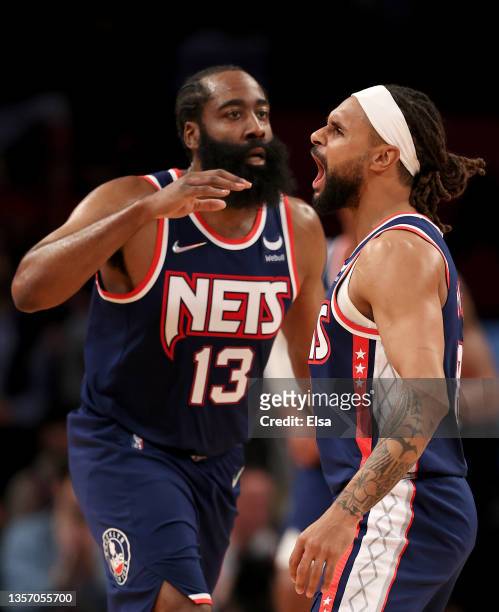 Patty Mills of the Brooklyn Nets celebrates his shot with teammate James Harden late in the fourth quarter against the Minnesota Timberwolves at...