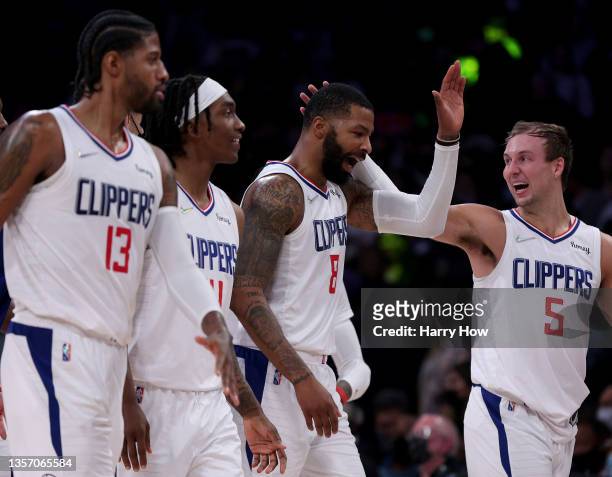 Marcus Morris Sr. #8 of the LA Clippers celebrates his three pointer with Luke Kennard, Terance Mann and Paul George during a 119-115 win over the...