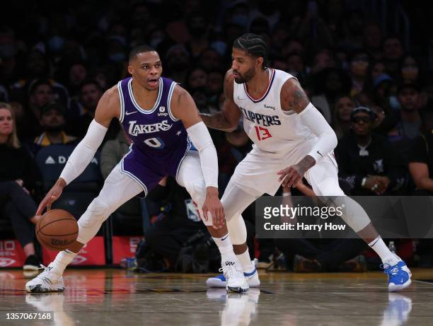 Russell Westbrook of the Los Angeles Lakers is defended by Paul George of the LA Clippers during a 119-115 Clippers win at Staples Center on December...