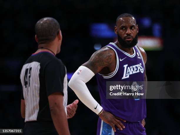 LeBron James of the Los Angeles Lakers talk with referee Eric Lewis during a 119-115 LA Clippers win at Staples Center on December 03, 2021 in Los...