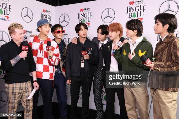 JoJo Wright speaks with RM, J-Hope, Jin, Jungkook, Suga, Jimin, and V of BTS backstage during iHeartRadio 102.7 KIIS FM's Jingle Ball 2021 presented...