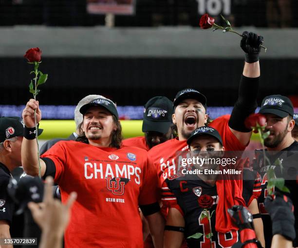 Quarterback Cameron Rising, defensive end Mika Tafua and wide receiver Britain Covey of the Utah Utes celebrate the team's 38-10 victory over the...