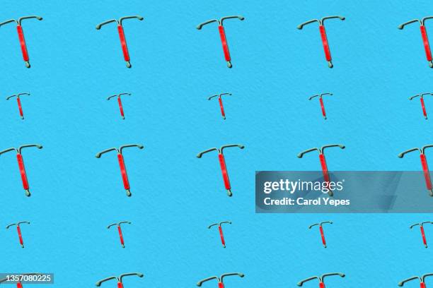 iud.concept hormonal contraception  seamless pattern in blue - iud stock pictures, royalty-free photos & images