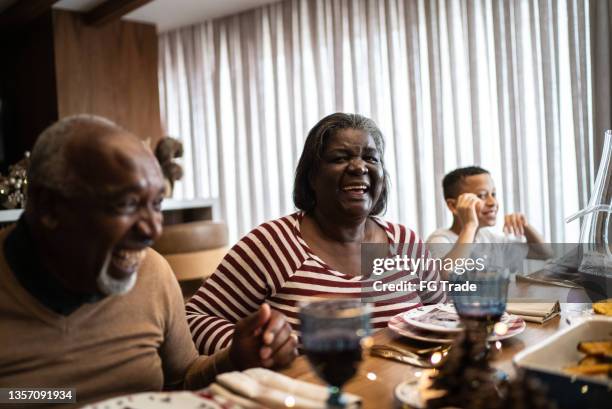 family reunited for christmas lunch or dinner at home - reunite stock pictures, royalty-free photos & images