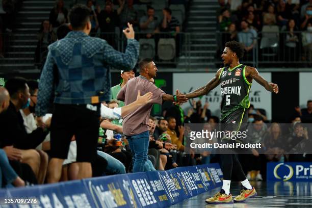 Xavier Munford of the Phoenix celebrates a three pointer with fans during the round one NBL match between South East Melbourne Phoenix and New...