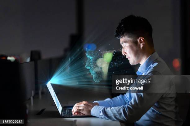 young man using facial recognition technology with laptop - facial recognition technology - fotografias e filmes do acervo