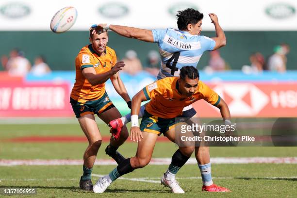 Joaquin De La Vega of Argentina, Dietrich Roache and Josh Turner of Australia compete for the ball during the Men’s Cup Semi-final match between...
