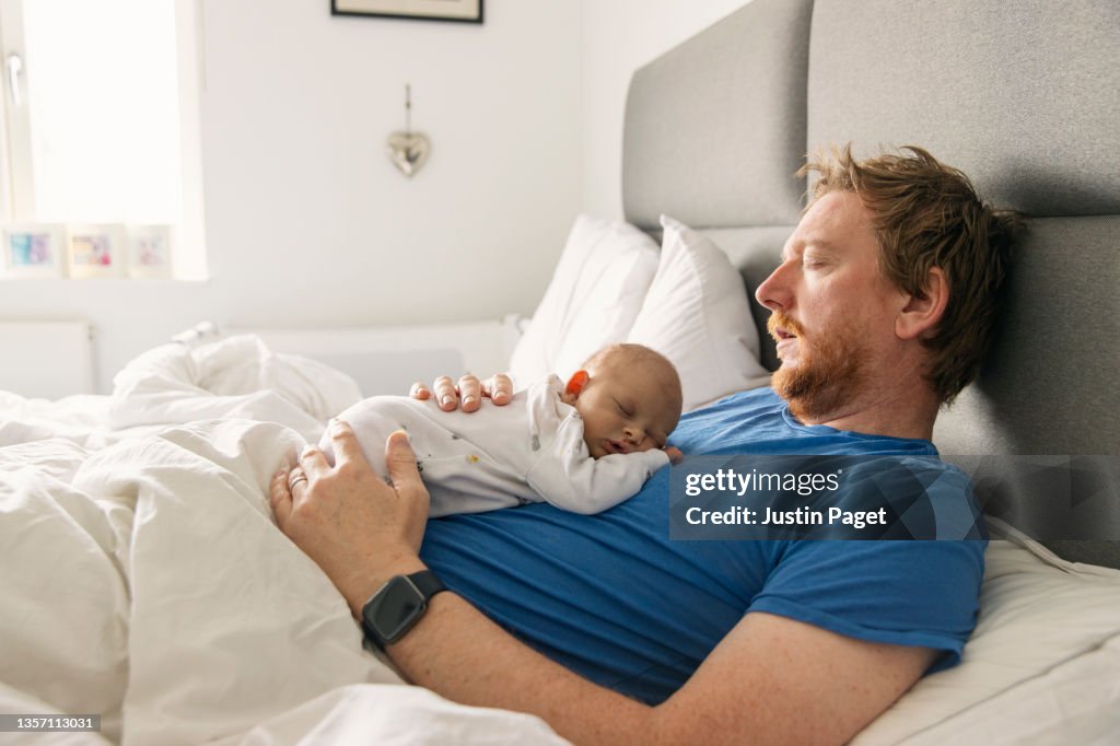 Newborn baby asleep on father's chest