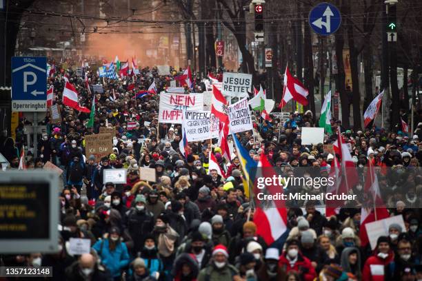 People protesting against lockdown measures and Covid vaccinations march through the city center during the fourth wave of the novel coronavirus...