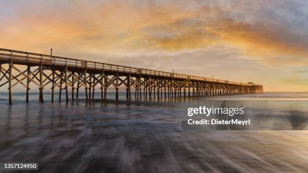 atlantic ocean sunset and long wooden pier in south carolina - myrtle beach stock pictures, royalty-free photos & images