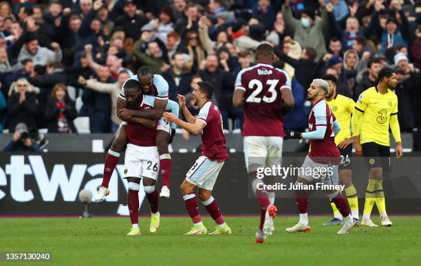 Arthur Masuaku celebrates with teammates Michail Antonio and Pablo Fornals of West Ham United after scoring their team's third goal during the...