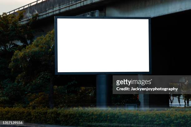 blank billboard on city street. outdoor advertising - billboard template stock-fotos und bilder