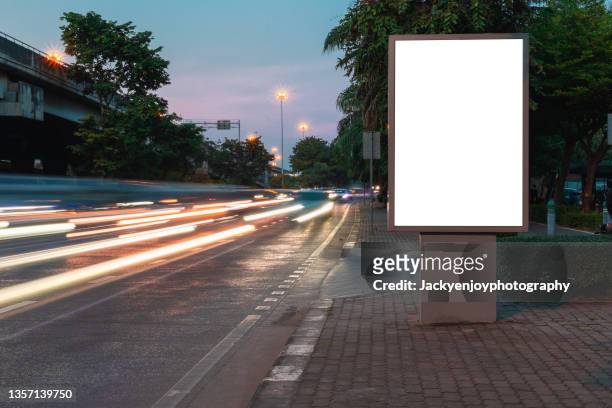blank billboard on city street. outdoor advertising - beleuchtet stock-fotos und bilder