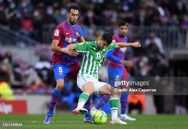 Guido Rodriguez of Real Betis is challenged by Sergio Busquets of FC Barcelona during the La Liga Santander match between FC Barcelona and Real Betis...
