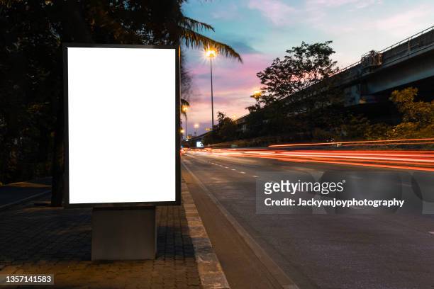 blank billboard on city street. outdoor advertising - bushaltestelle stock-fotos und bilder