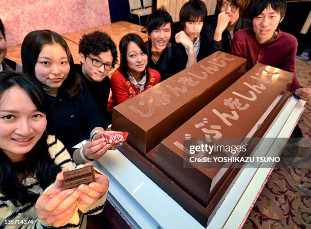 University of Tokyo students display a large sized KitKat chocolate bar, measuring 100 x 60 x 20cm and weighing 80kg, as they encourage high school...