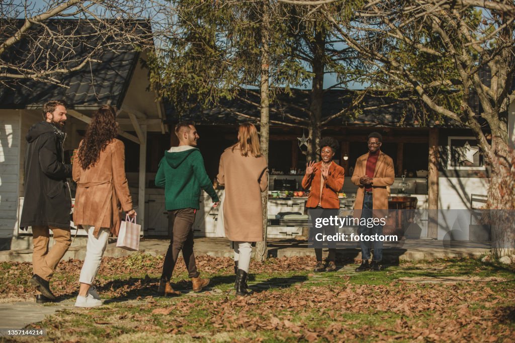 Group of people arriving at their friends' house