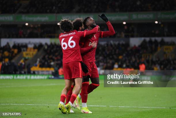 Divock Origi of Liverpool celebrates with Trent Alexander-Arnold and Mohamed Salah after scoring their side's first goal during the Premier League...