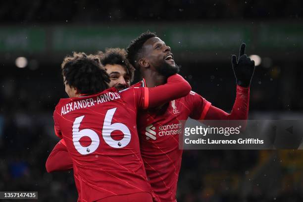Divock Origi of Liverpool celebrates with Trent Alexander-Arnold and Mohamed Salah after scoring their side's first goal during the Premier League...