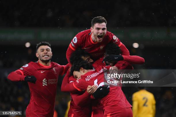 Divock Origi of Liverpool celebrates with Alex Oxlade-Chamberlain, Andrew Robertson, Trent Alexander-Arnold and Mohamed Salah after scoring their...