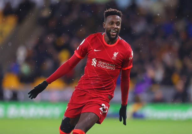 Divock Origi of Liverpool celebrates after scoring the winning goal during the Premier League match between Wolverhampton Wanderers and Liverpool at...