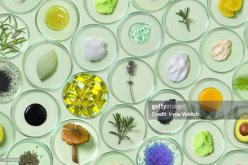 Organic, bio cosmetics healthy concept with Petri Dishes with natural plants and beauty products.