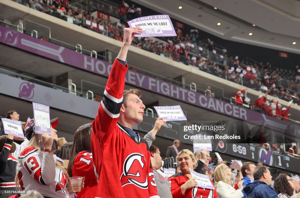 Devils Flyers Fans of the New Jersey Devils hold up I fight for cancer cards during ...