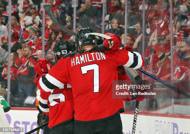 Jesper Bratt of the New Jersey Devils celebrates his third period game winning goal with Dougie Hamilton and teammates against the Philadelphia...