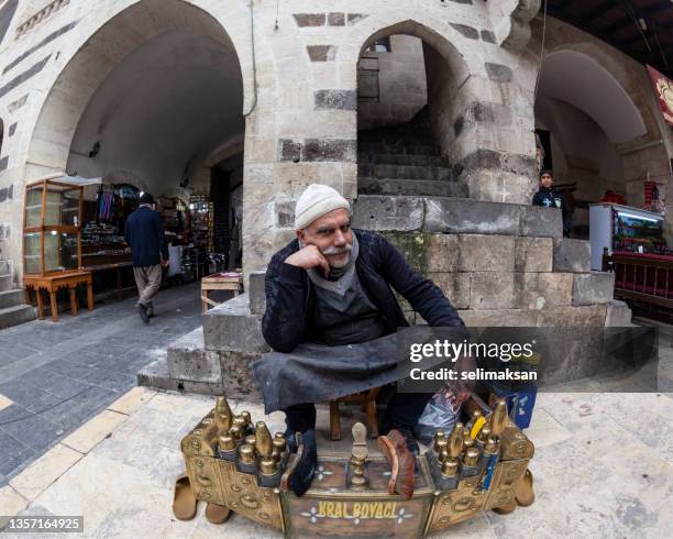 photo of shoeblack sitting on the street, sanliurfa, turkey - şanlıurfa stock pictures, royalty-free photos & images