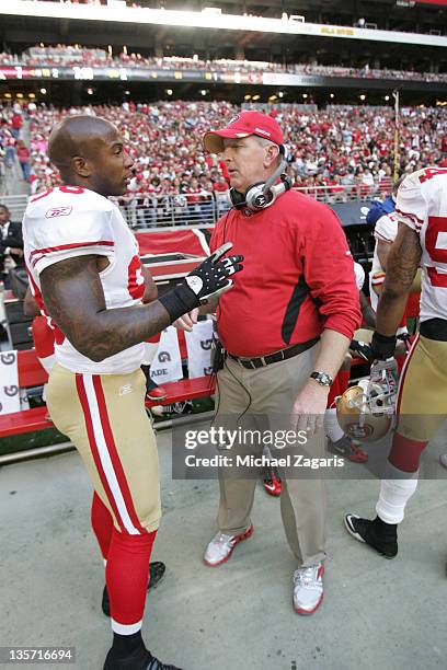 Linebackers Coach Jim Leavitt of the San Francisco 49ers talks with Parys Haralson during the game against the Arizona Cardinals at the University of...