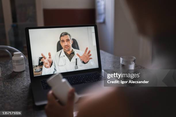 doctor giving online consultation - facetime-screen-man stock pictures, royalty-free photos & images