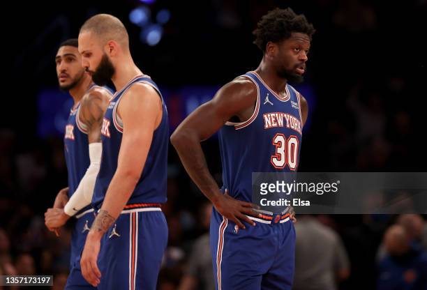 Julius Randle of the New York Knicks reacts to the loss with teammates Evan Fournier and Obi Toppin late in the fourth quarter against the Denver...